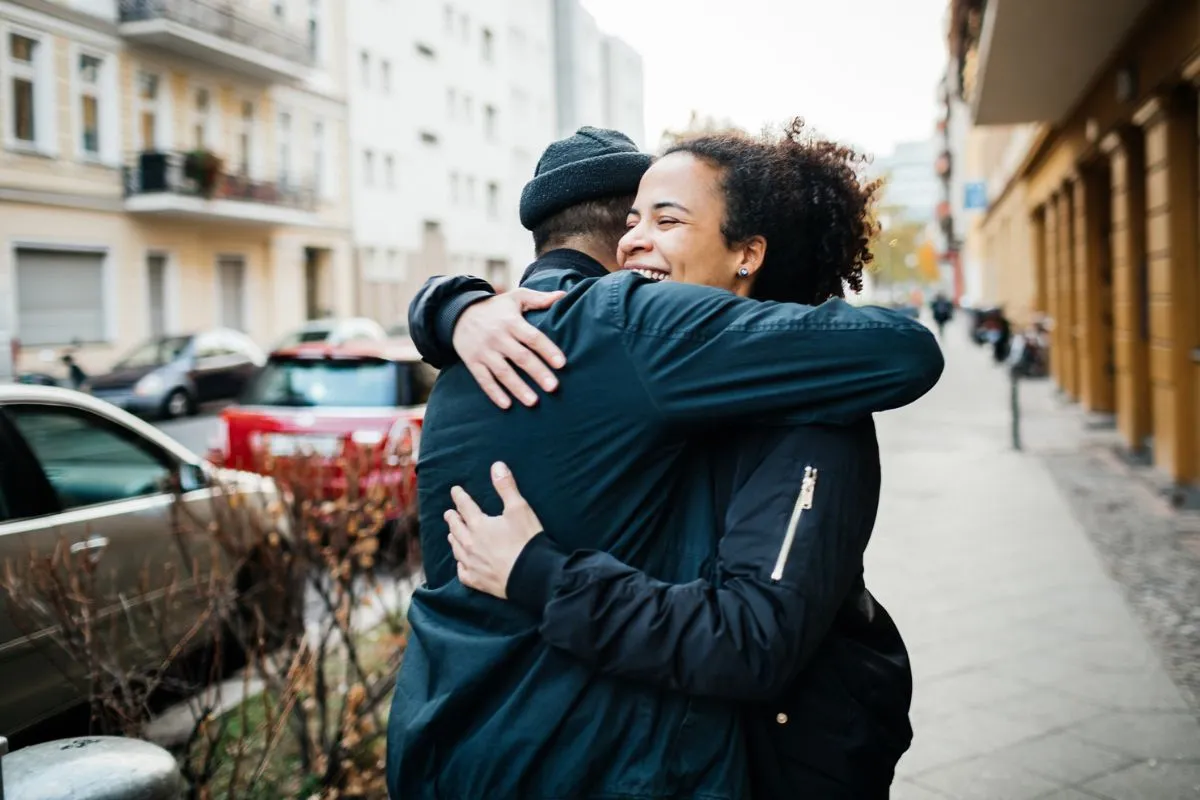 Friends Hugging In The Street